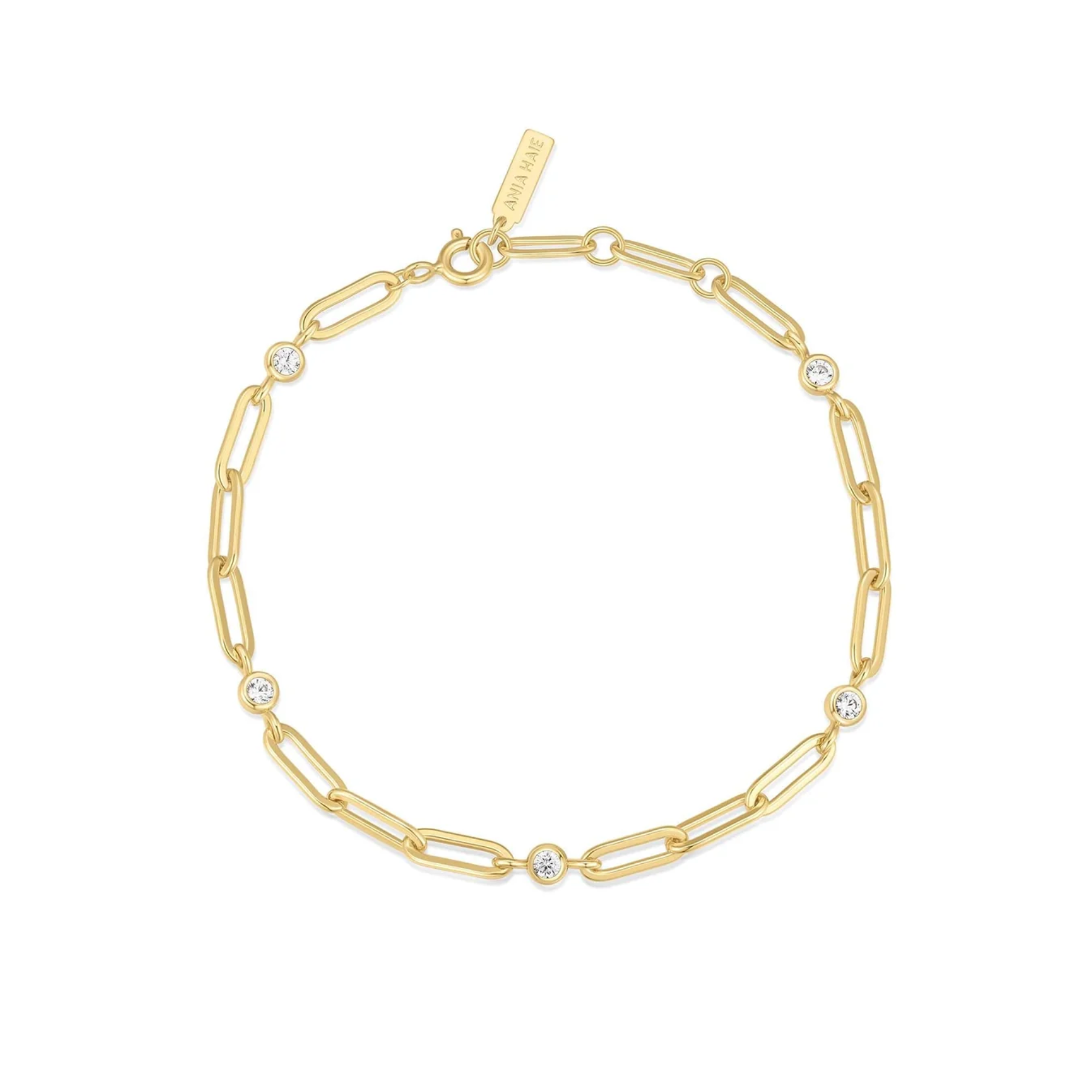 Gold chain bracelet with diamond-like stones on a white background
