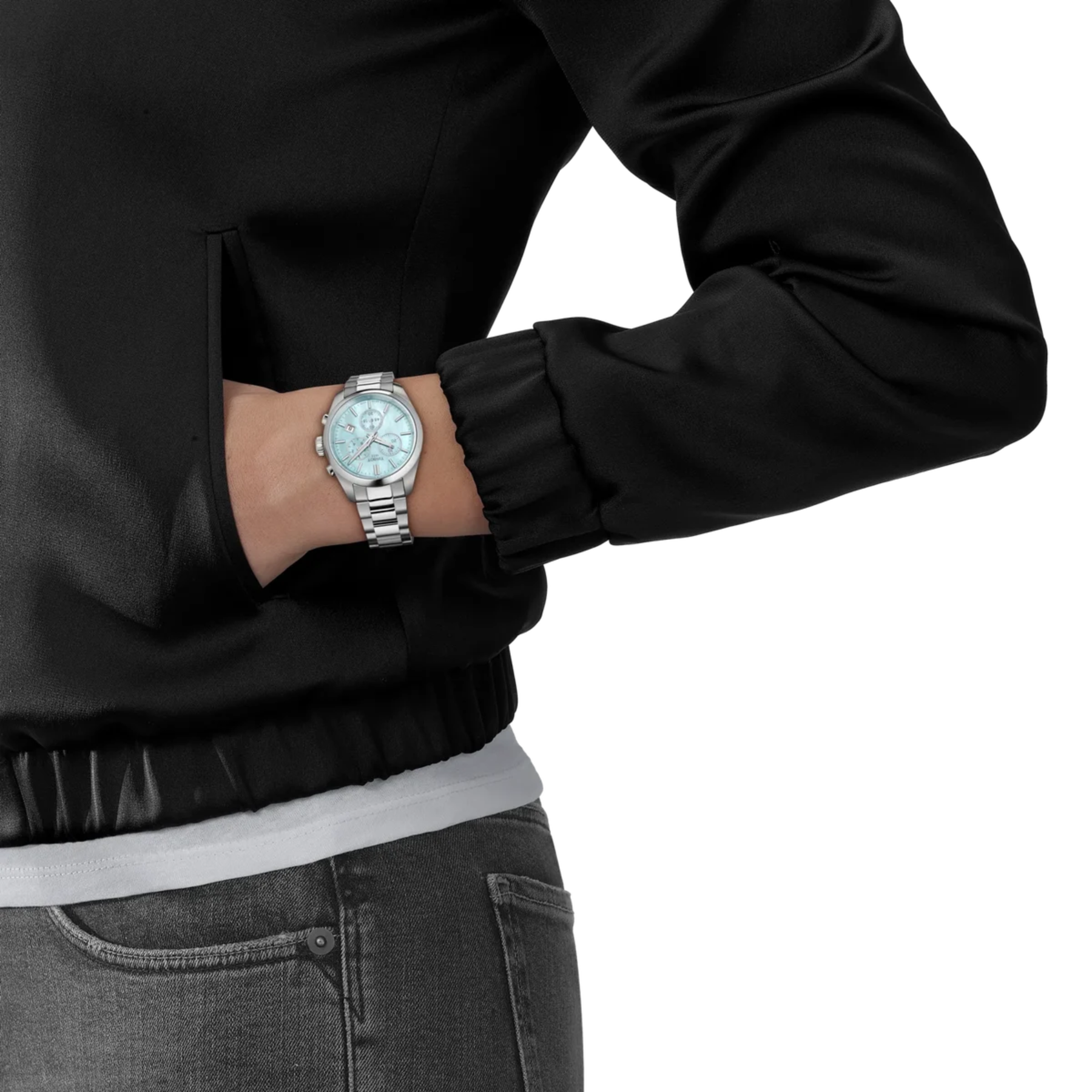 Person wearing a silver watch on a plain background