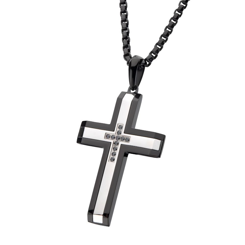 Black and silver cross pendant on a chain against a white background